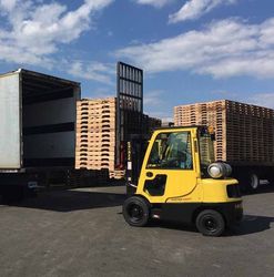 Forlift loading pallets onto a box truck for delivery