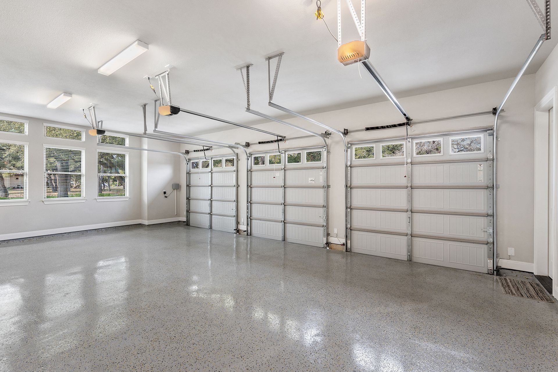 A large empty garage with a lot of garage doors.