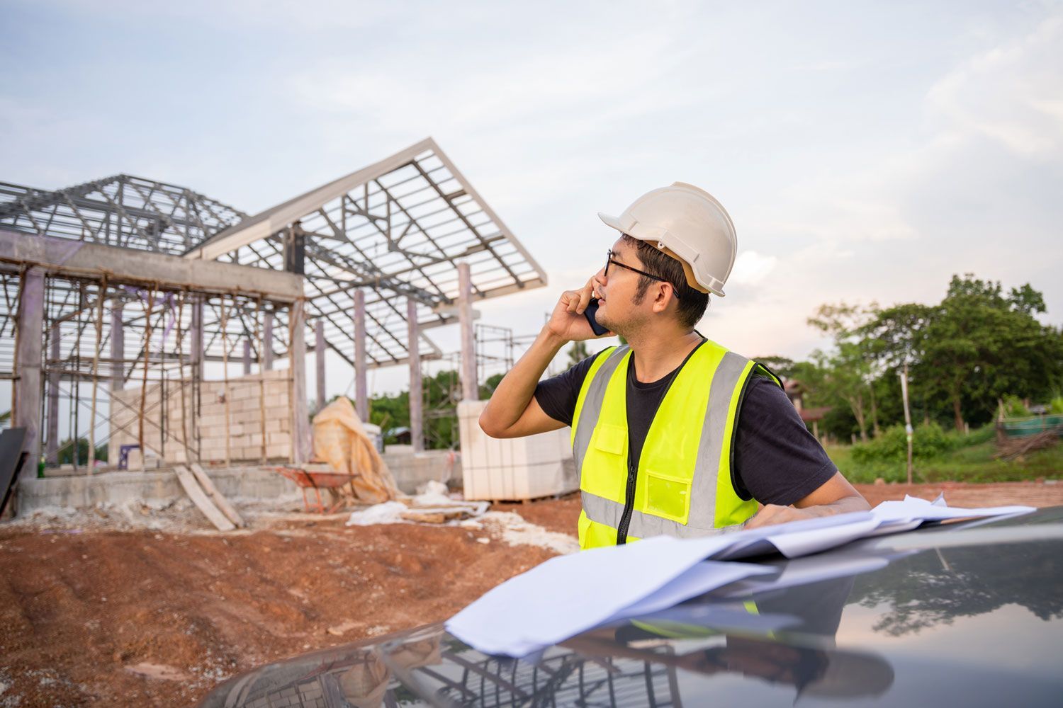 Contractor planning building supplies needs at a construction site.