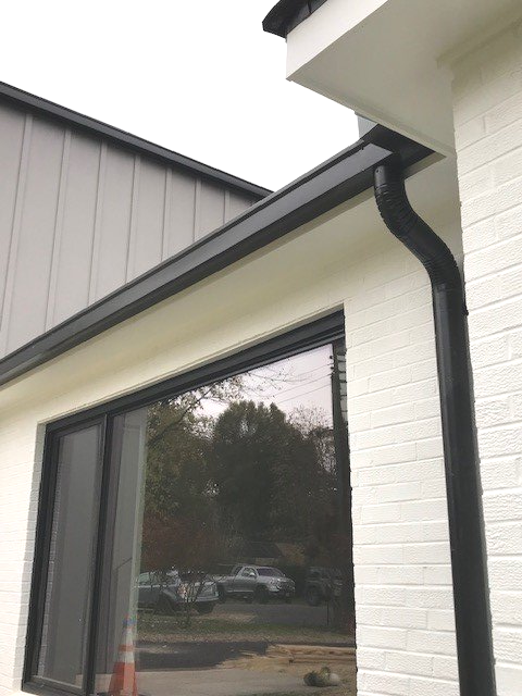 Man Cutting the Downspout — Charlottesville, VA — Straightedge Inc. Man Cutting the Downspout — Charlottesville, VA — Straightedge Inc.