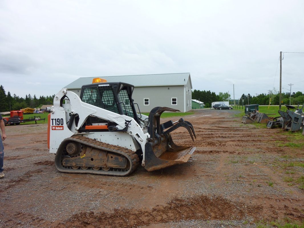 A man is pouring concrete into a wooden frame.