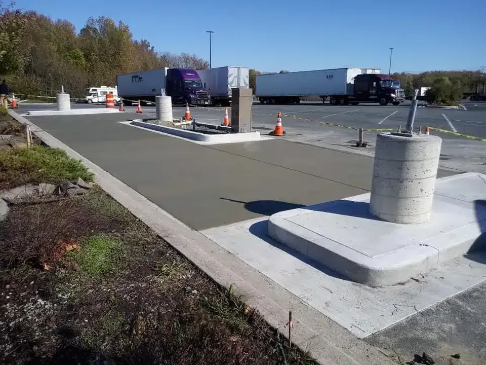 A man is leveling a concrete floor with a level.