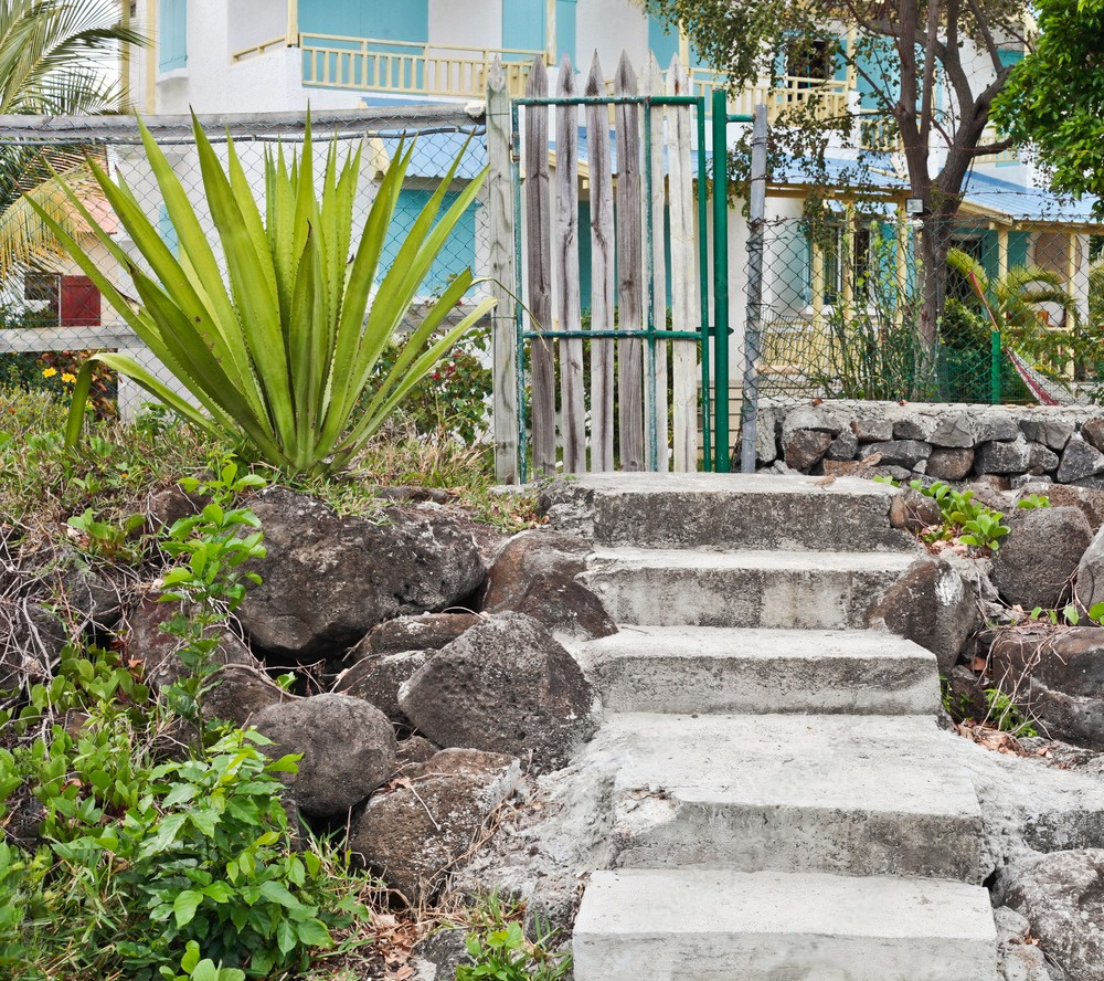 A set of concrete stairs leading up to a house