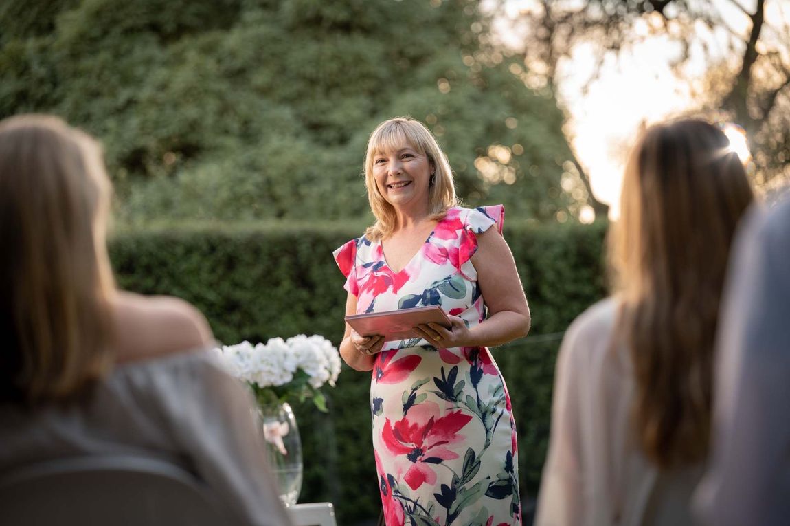 a beautiful women standing in pink floral dress