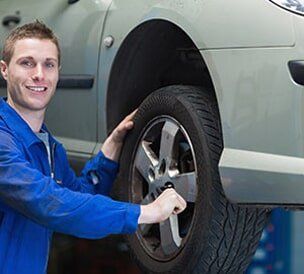 Man with Tire - Auto Repair in Glenmont NY