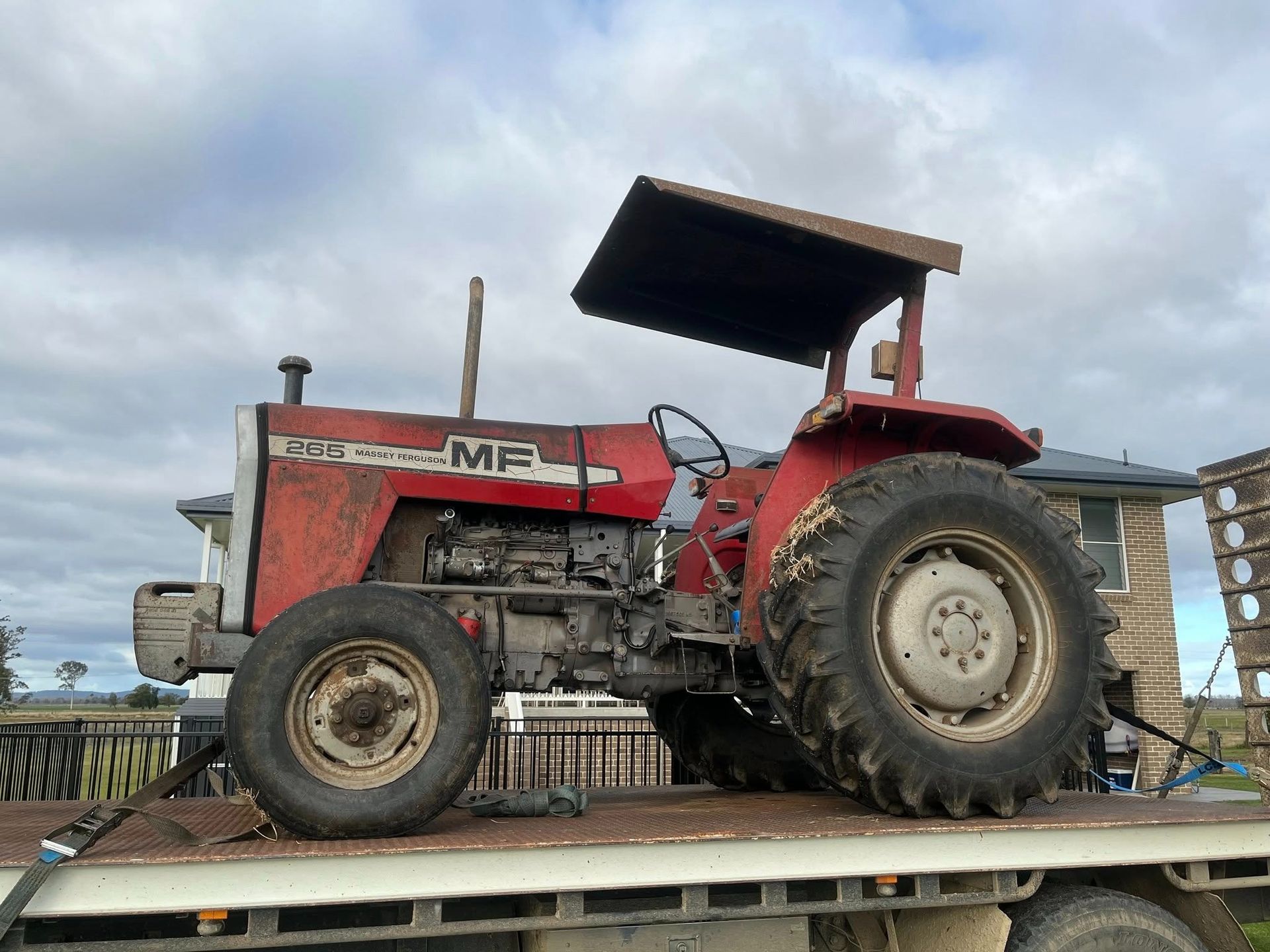 Red Tractor Sitting on a Trailer