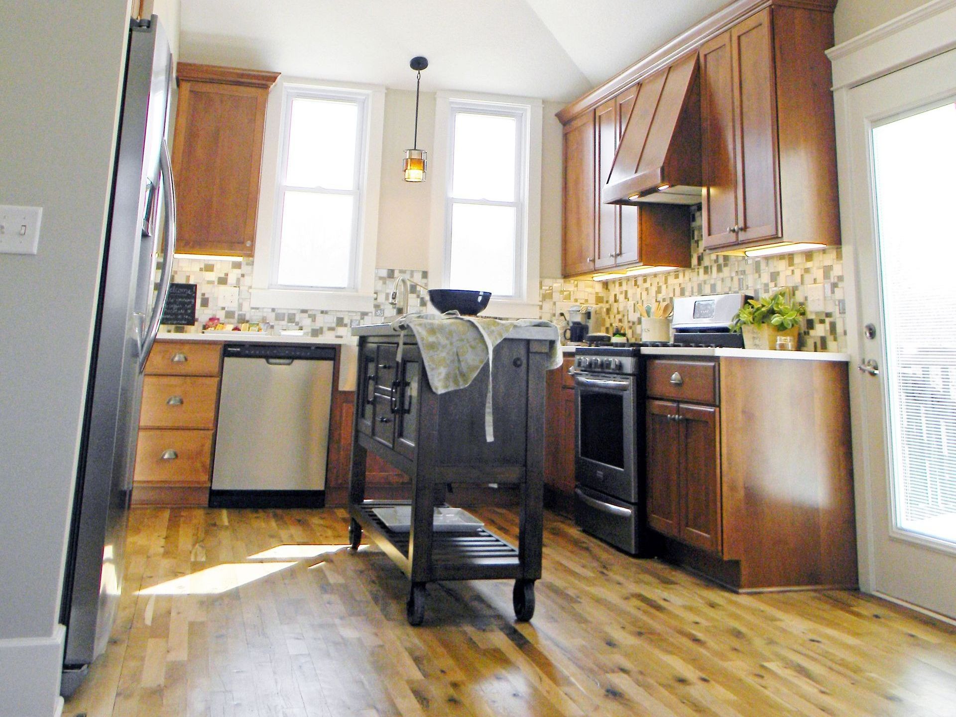 A kitchen with wooden cabinets and stainless steel appliances