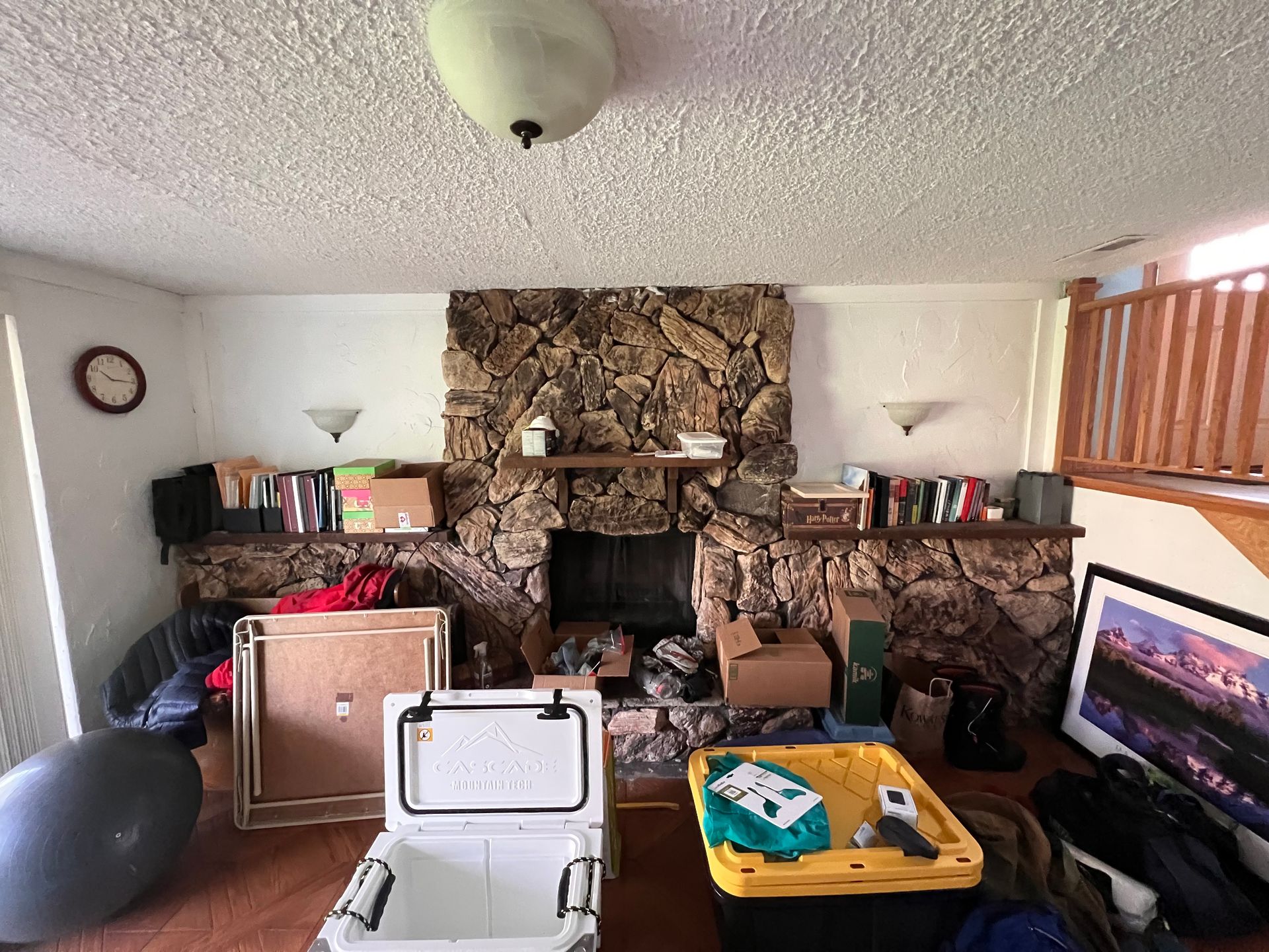 A living room filled with lots of boxes and a fireplace.