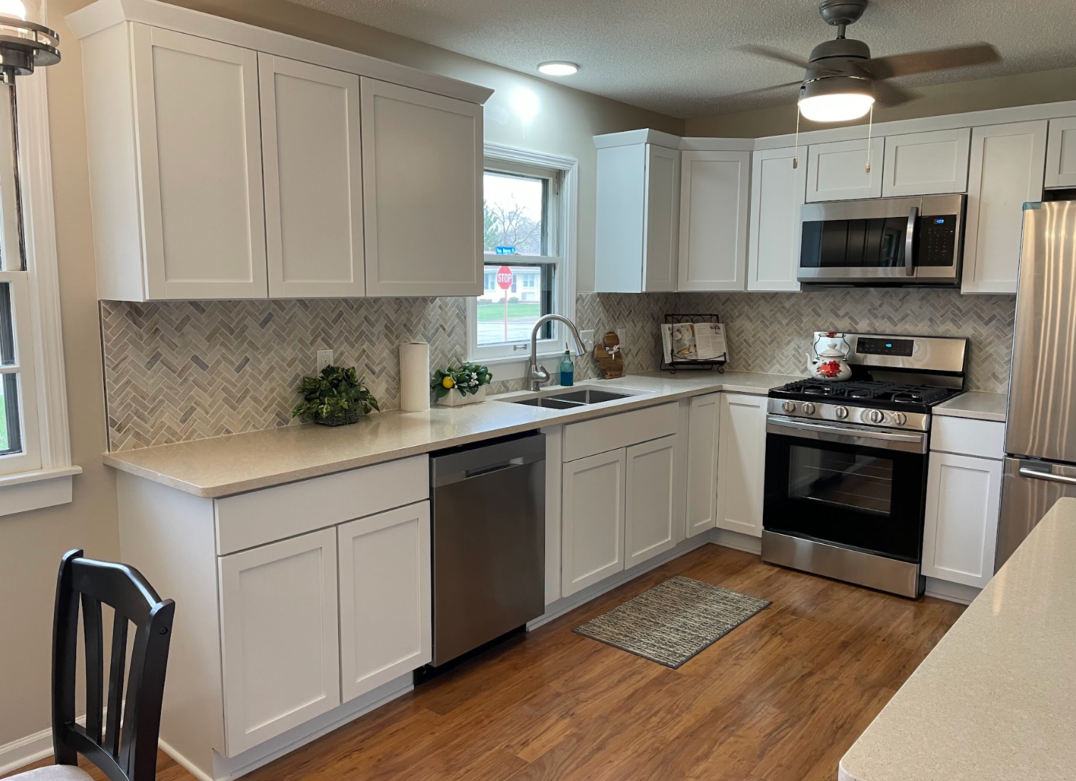 A kitchen with white cabinets and stainless steel appliances