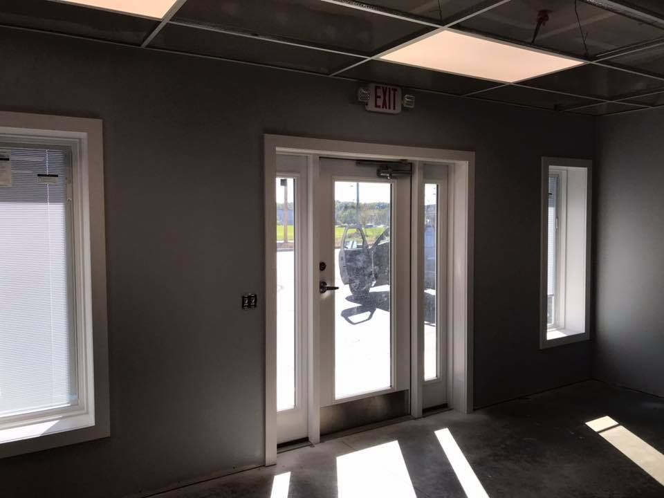 A room with a door and a sign that says exit