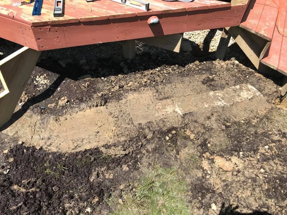 A wooden deck is being built on top of a pile of dirt.