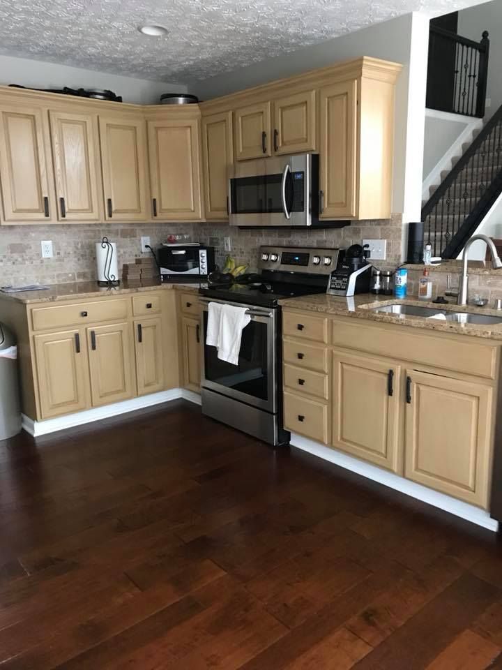 A kitchen with stainless steel appliances and wooden cabinets.