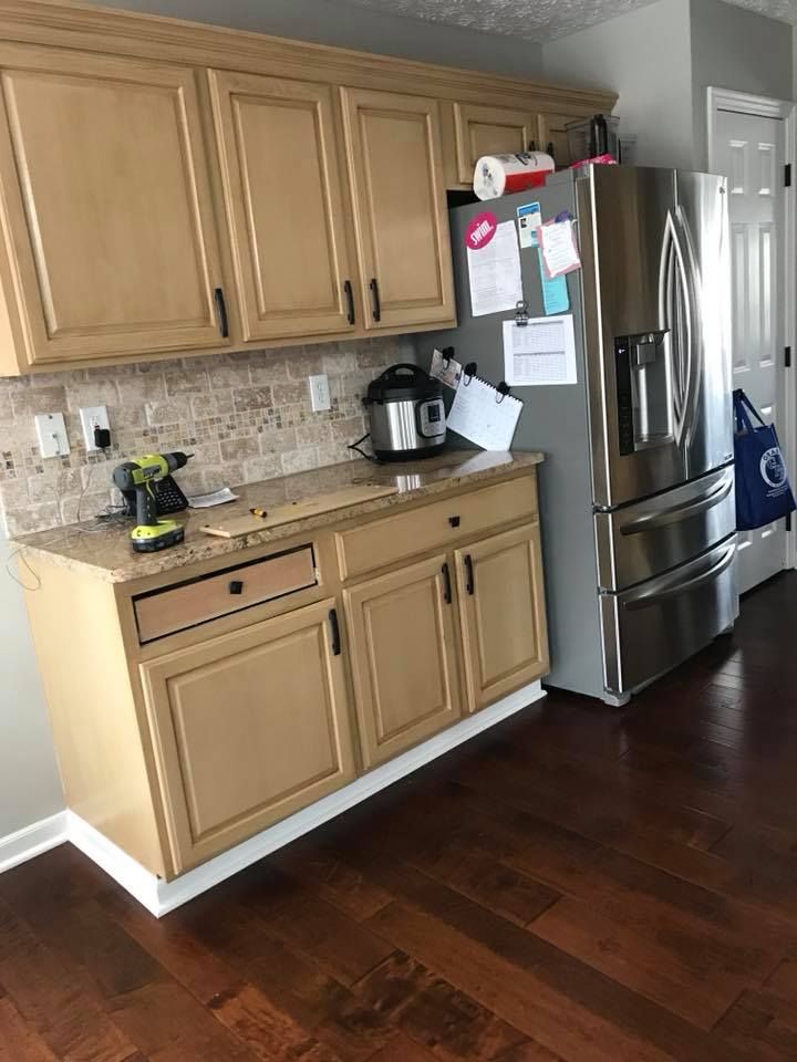 A kitchen with stainless steel appliances and wooden cabinets.
