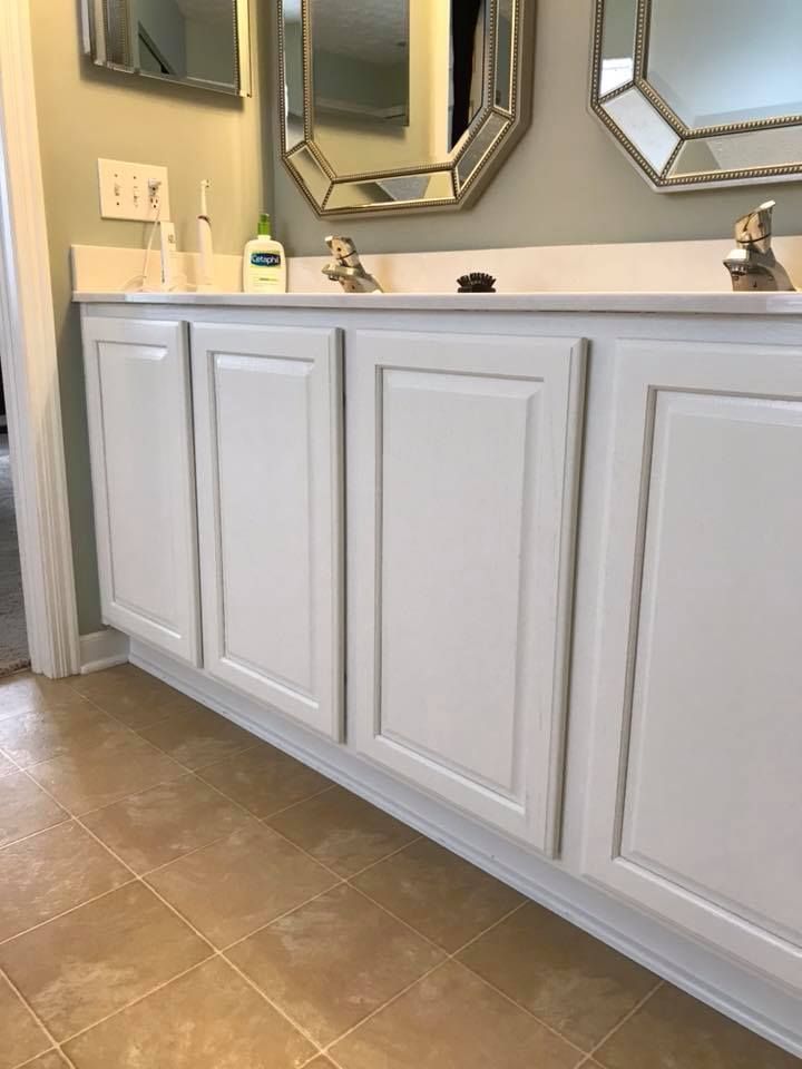 A bathroom vanity with two sinks and two mirrors.
