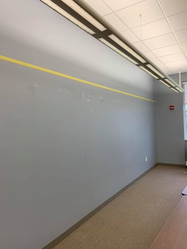 An empty hallway with a yellow line on the wall