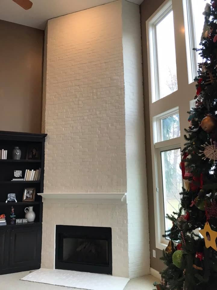 A living room with a fireplace and a christmas tree
