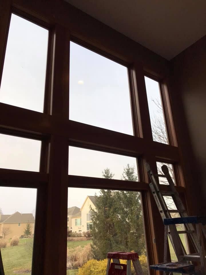 A large window with a ladder in front of it