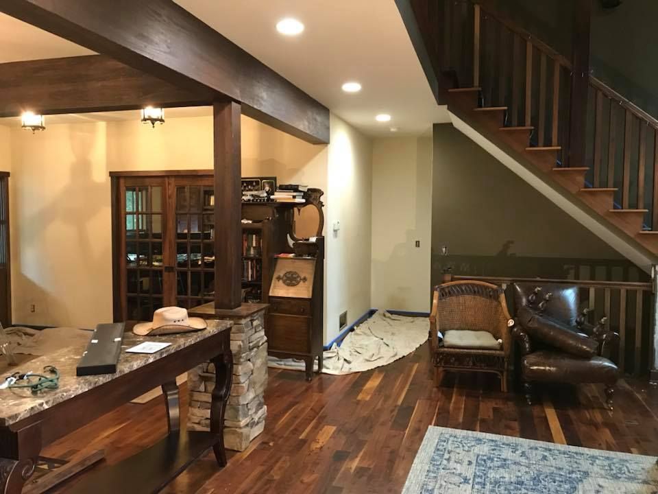 A living room with hardwood floors and a staircase