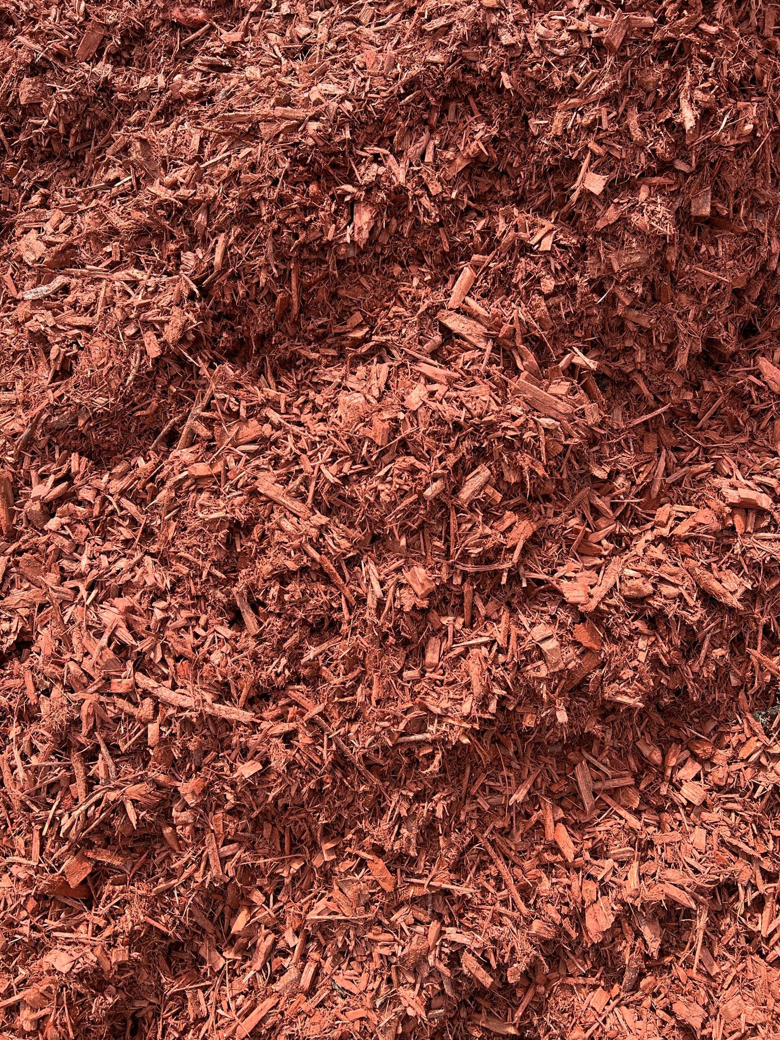 Reddish-brown mulch covering the ground, composed of shredded wood and leaves.