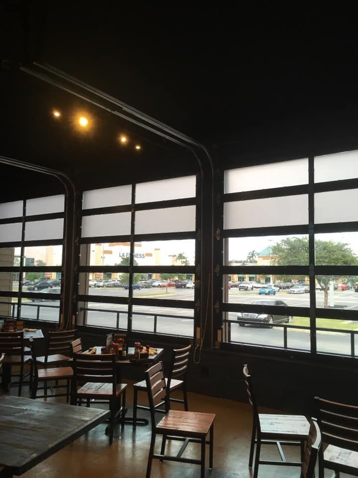 A restaurant with a lot of windows and tables and chairs