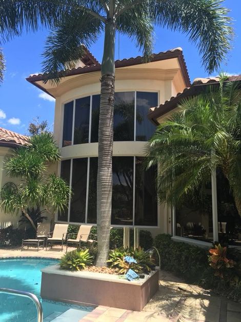 A large house with a swimming pool in front of it