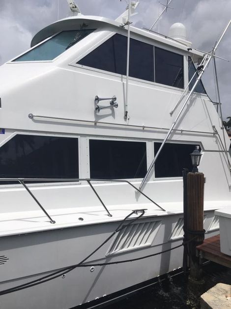 A large white boat is docked at a dock