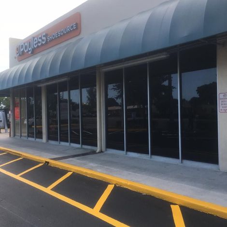 A payless shoesource store with a blue awning