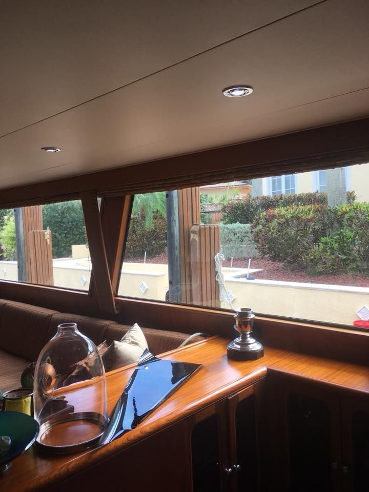 A boat with a lot of windows and a table with a vase on it.