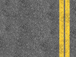Asphalt road surface with two yellow center lines on the right Asphalt road surface with two yellow center lines on the right