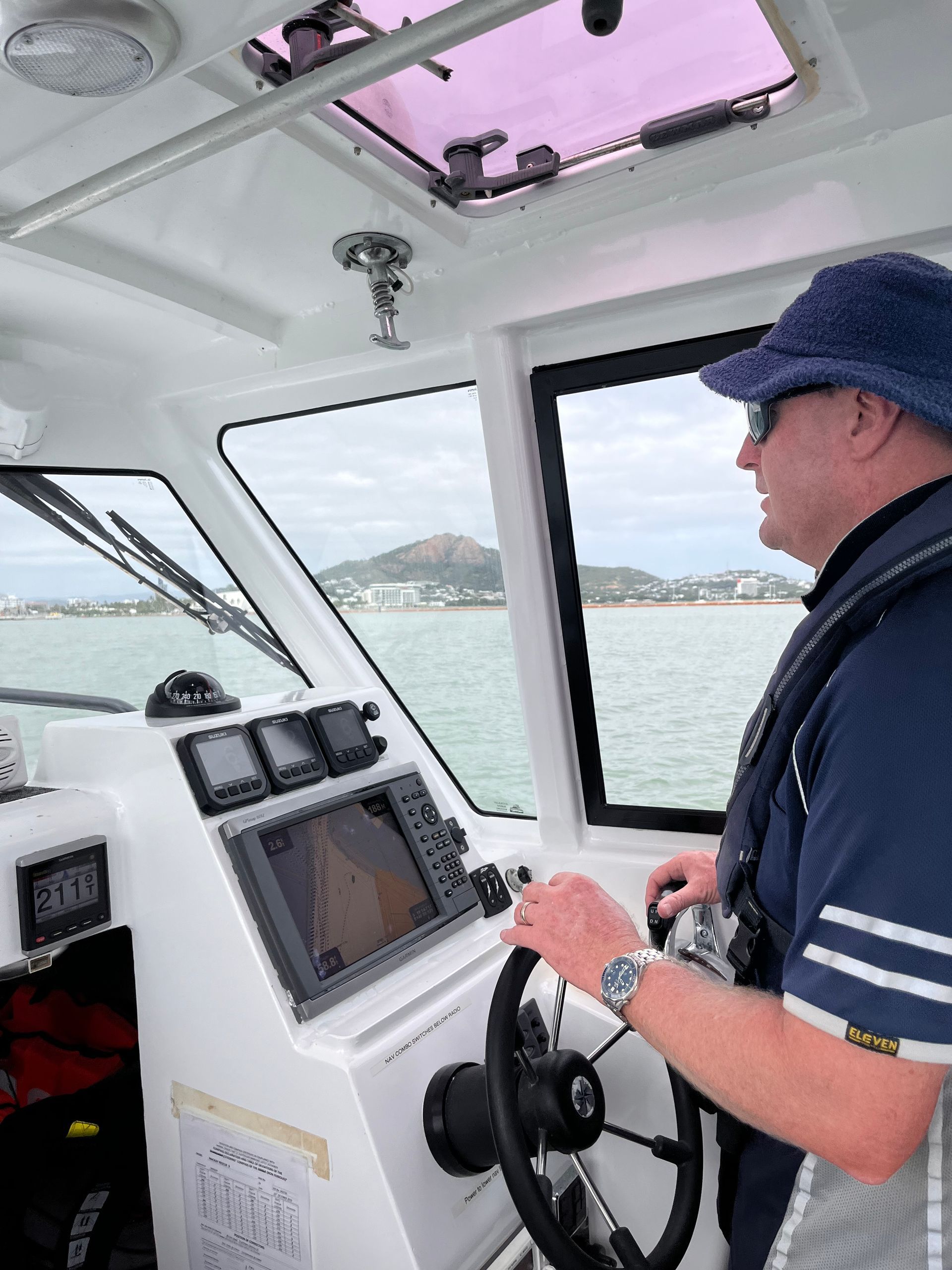 Man Cleaning Side of Boat - Boat Transportation in South Townsville, QLD