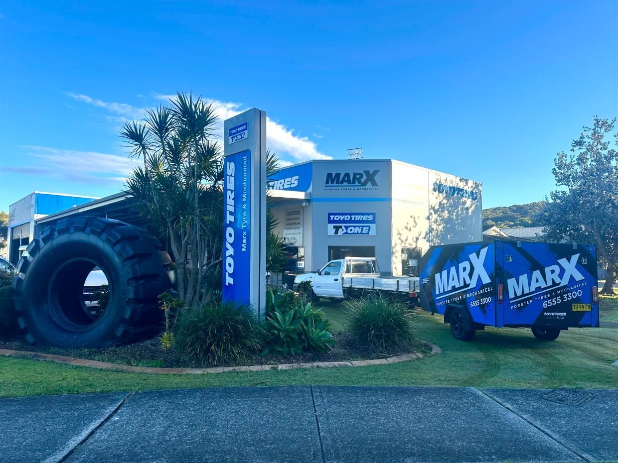 A Large Tyre is Sitting in Front of a Tyre Store  — Marx Forster Tyres & Mechanical In Forster, NSW