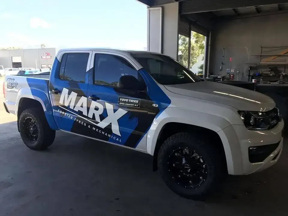 A blue and white Marx truck is parked in a garage — Marx Forster Tyres & Mechanical In Forster, NSW