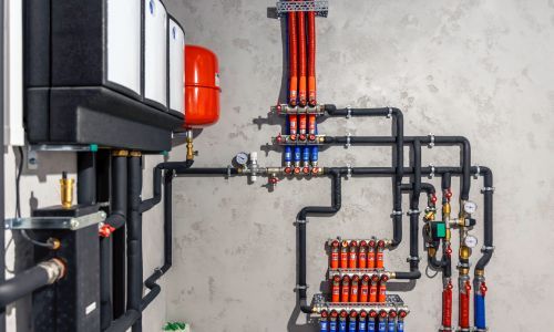 A bunch of pipes are connected to each other in a room.
