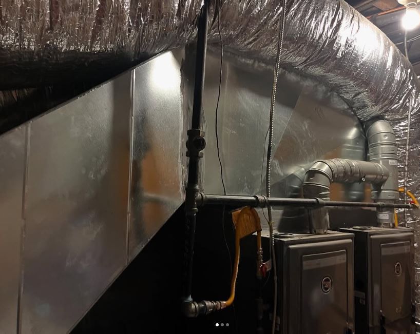 A room with a lot of pipes and ducts in it