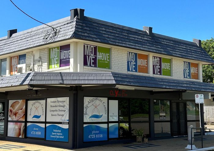 A building with a lot of windows and signs on it