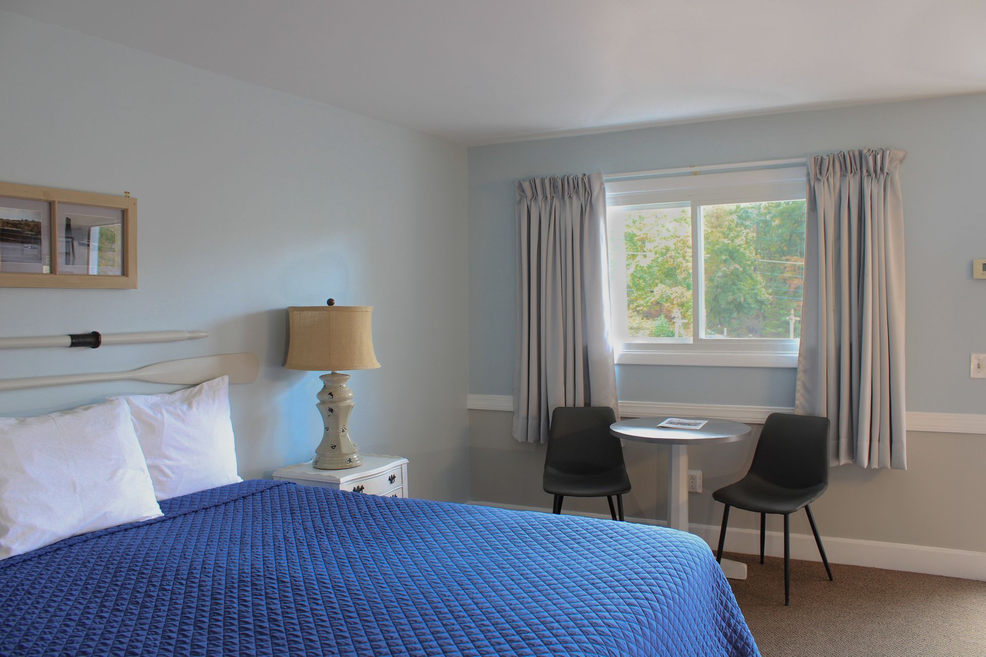 A hotel room with a king size bed and a bathroom.