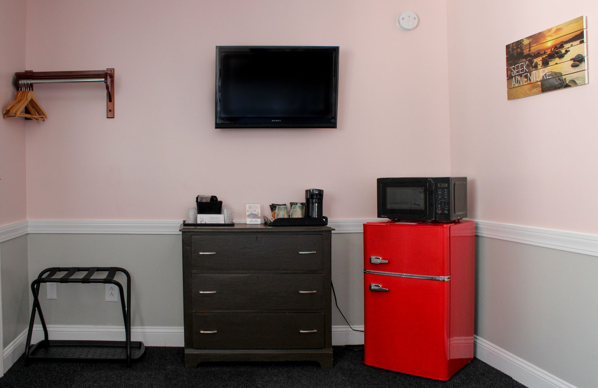 A hotel room with two beds , a table and chairs.