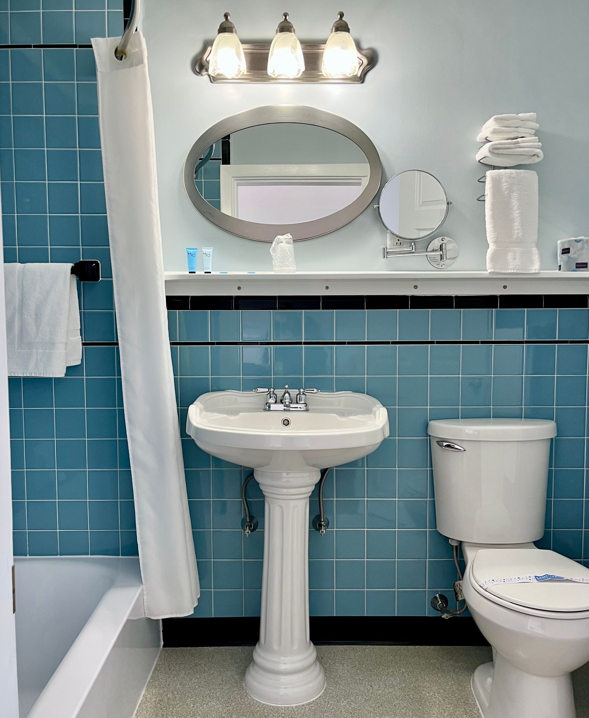 A white building with a blue awning that says docksport inn