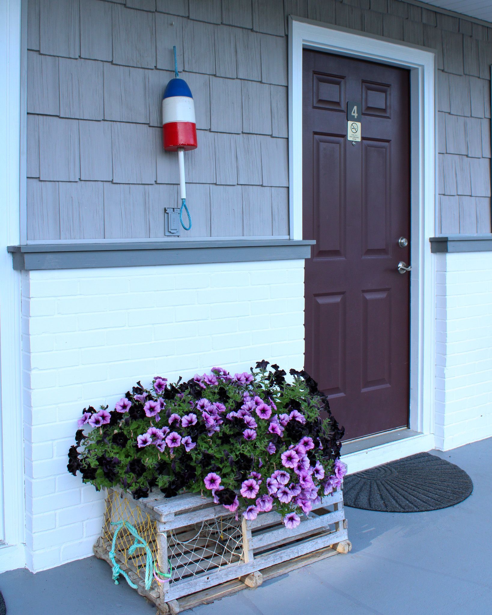 A hotel room with two beds and a picture on the wall.