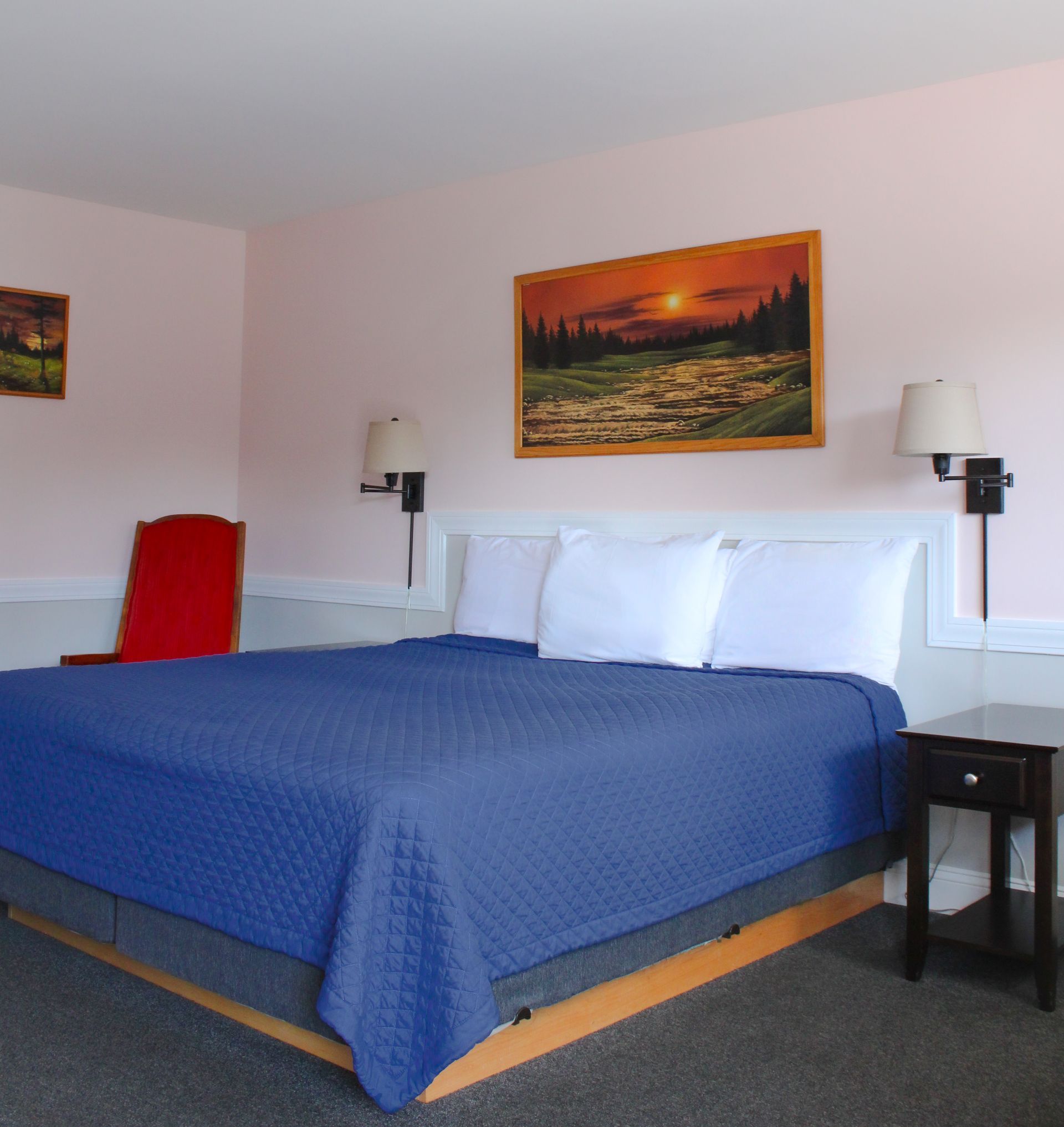 A hotel room with two beds , a table and chairs.