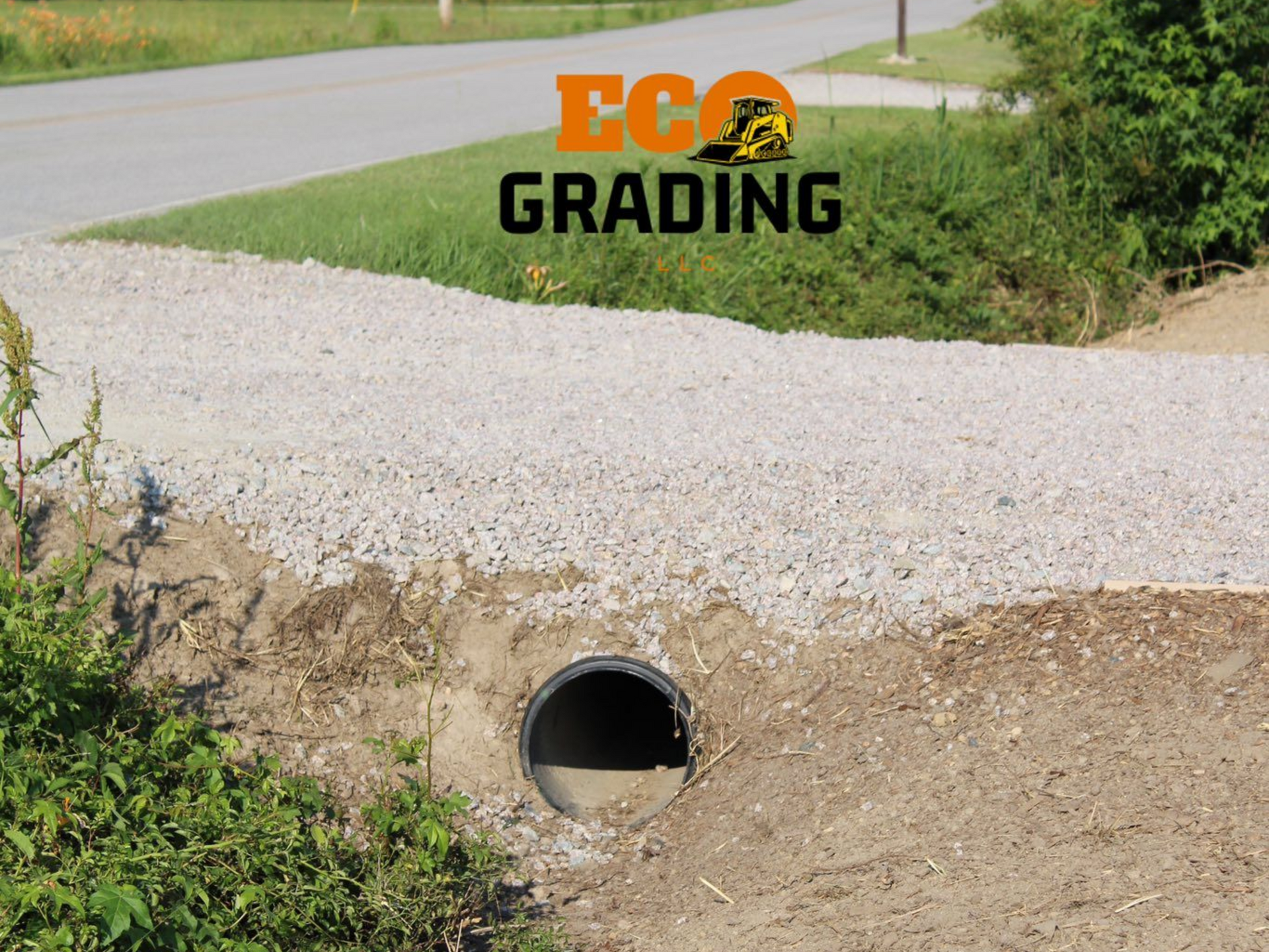 Culvert under gravel road, leading to a street, Eco Grading logo visible.