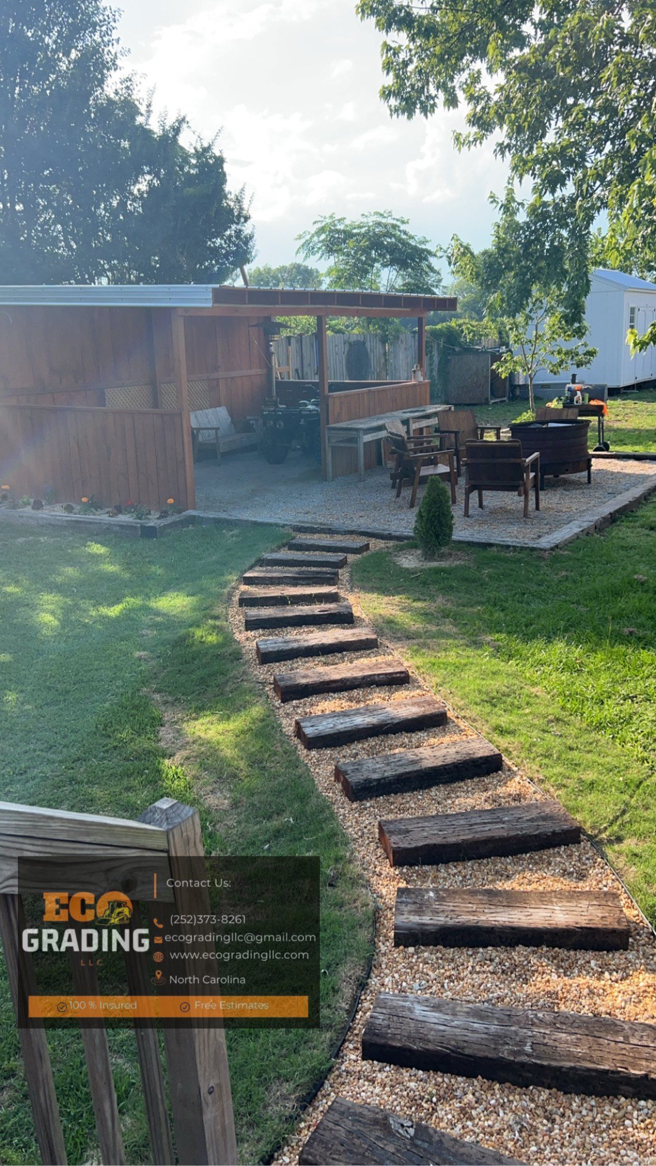 Pathway of wooden steps leads to an outdoor seating area with a structure and greenery.