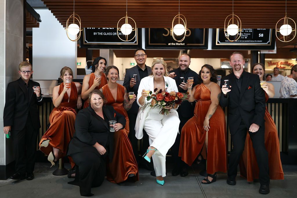 wedding party at a bar dressed in black and copper