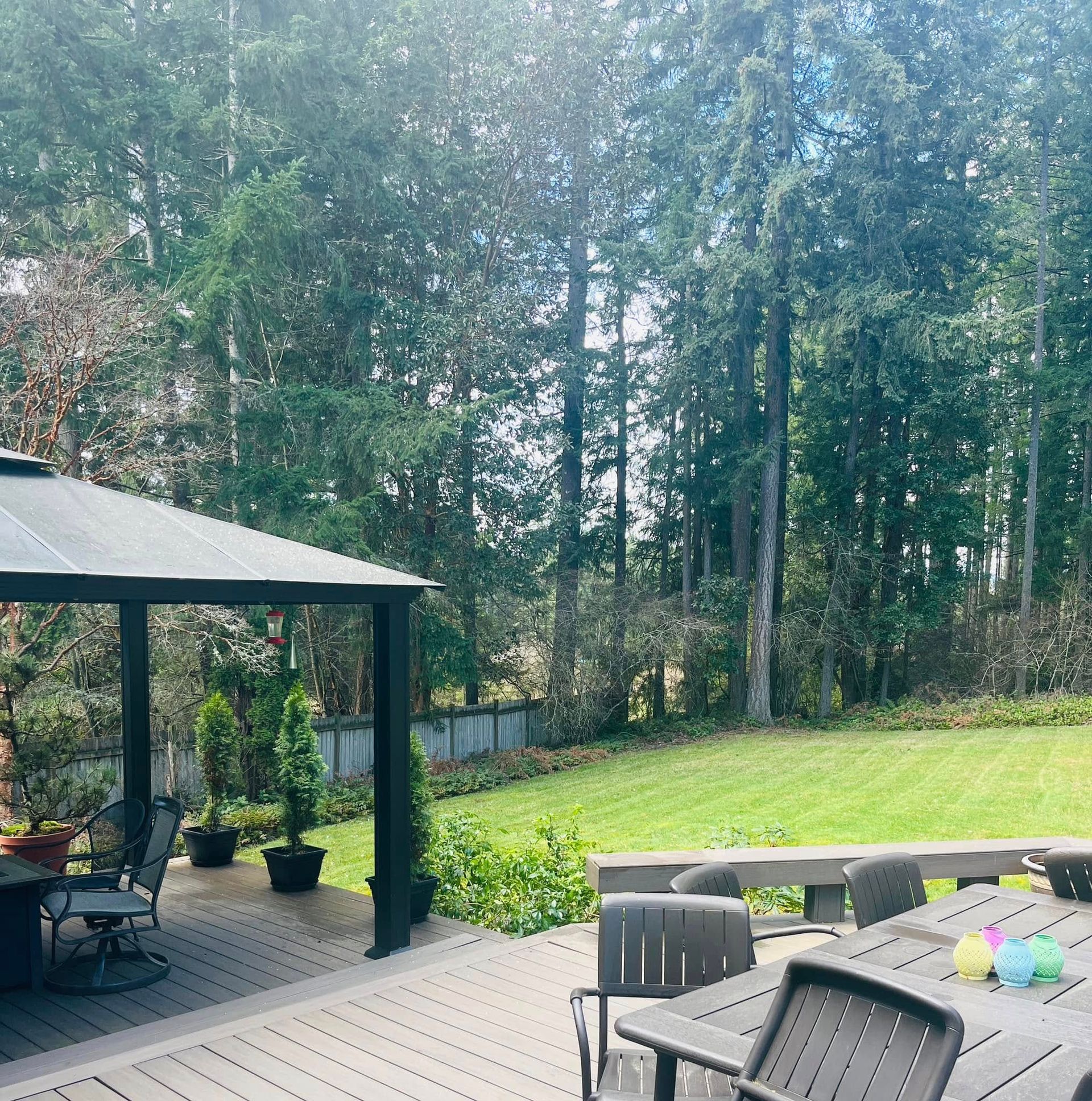 A deck with a gazebo and a table and chairs