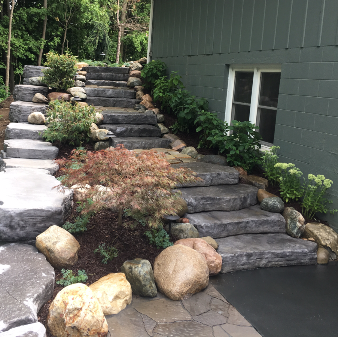 Stone steps with landscaping leading up to a building.