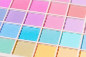 A close up of a palette of colorful eye shadows.