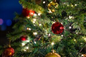 A close up of a christmas tree with decorations and lights.