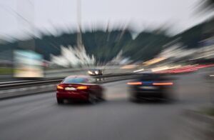 A blurry picture of two cars driving down a highway