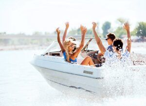 A group of people are riding a speed boat on a lake.