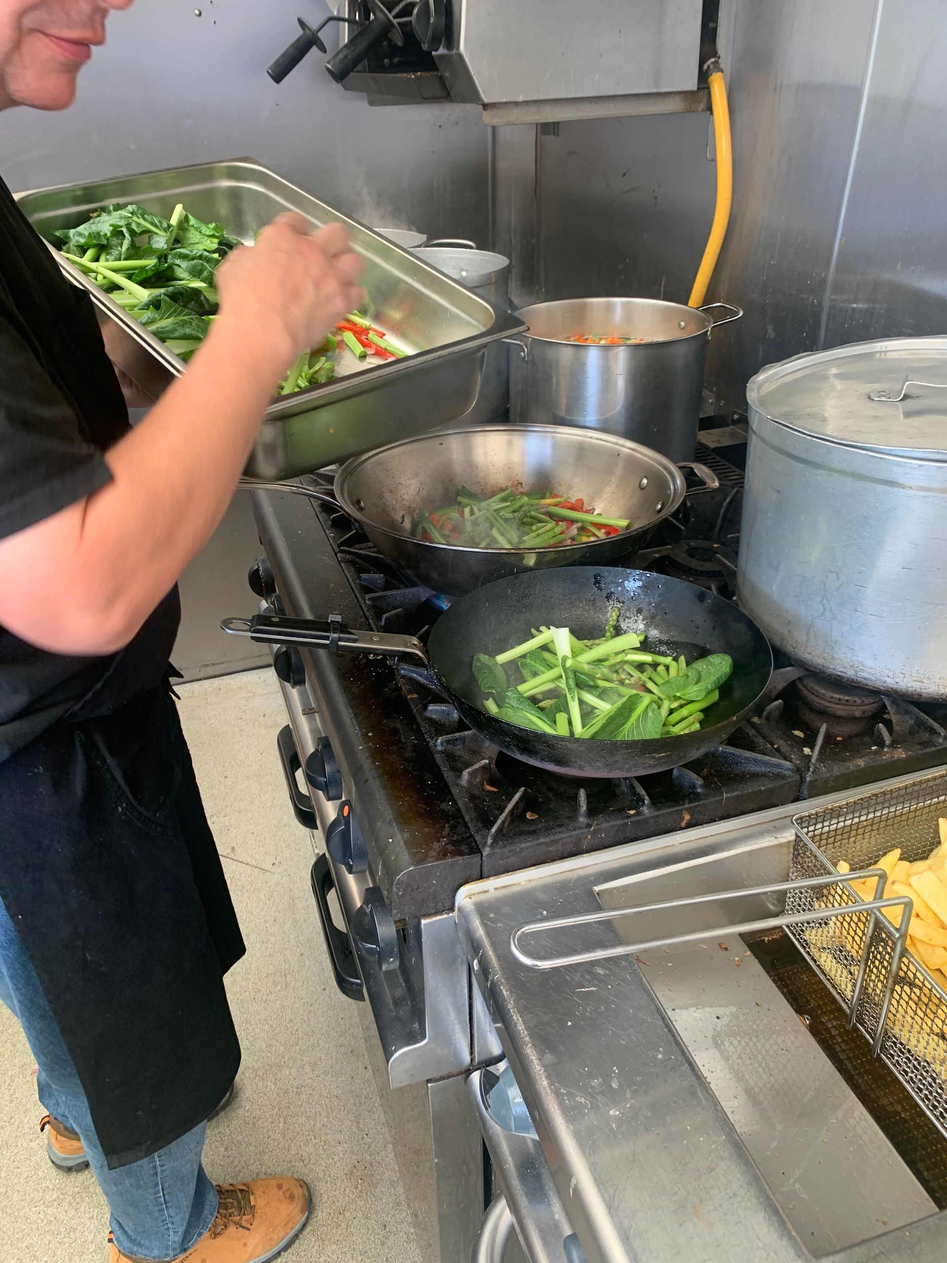 Location caterers preparing fresh vegan dishes